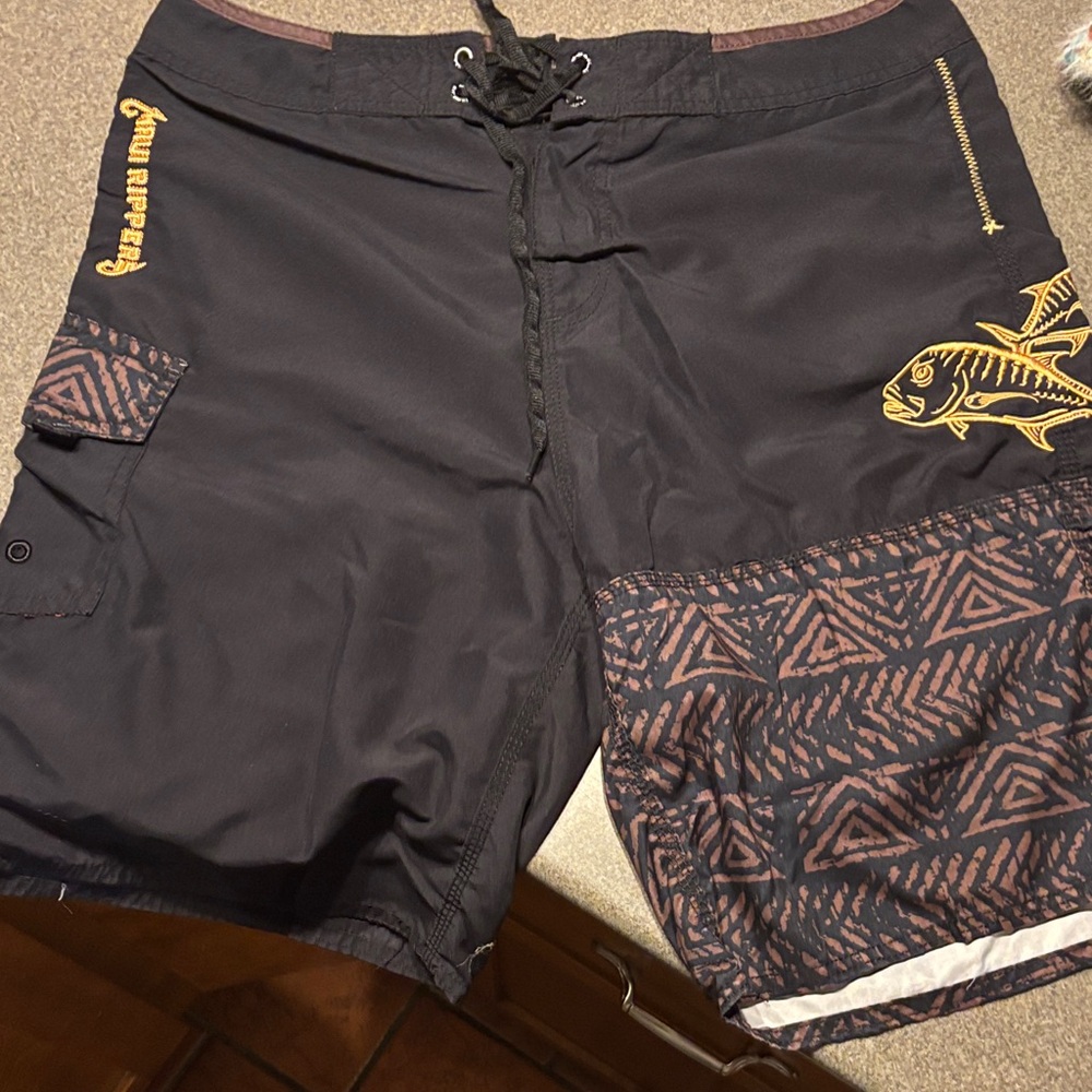 Pelagic Men's Black Board Shorts with Gold Fish Design